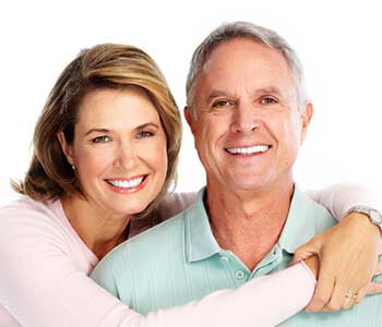 Happy and smiling couple in front of white background