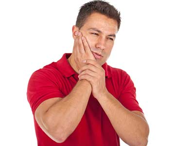 young man with a toothache tooth pain